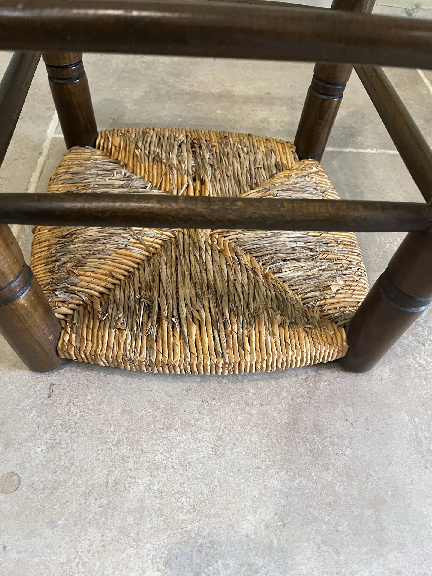 Wooden stool with a straw seat