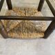 Wooden stool with a straw seat