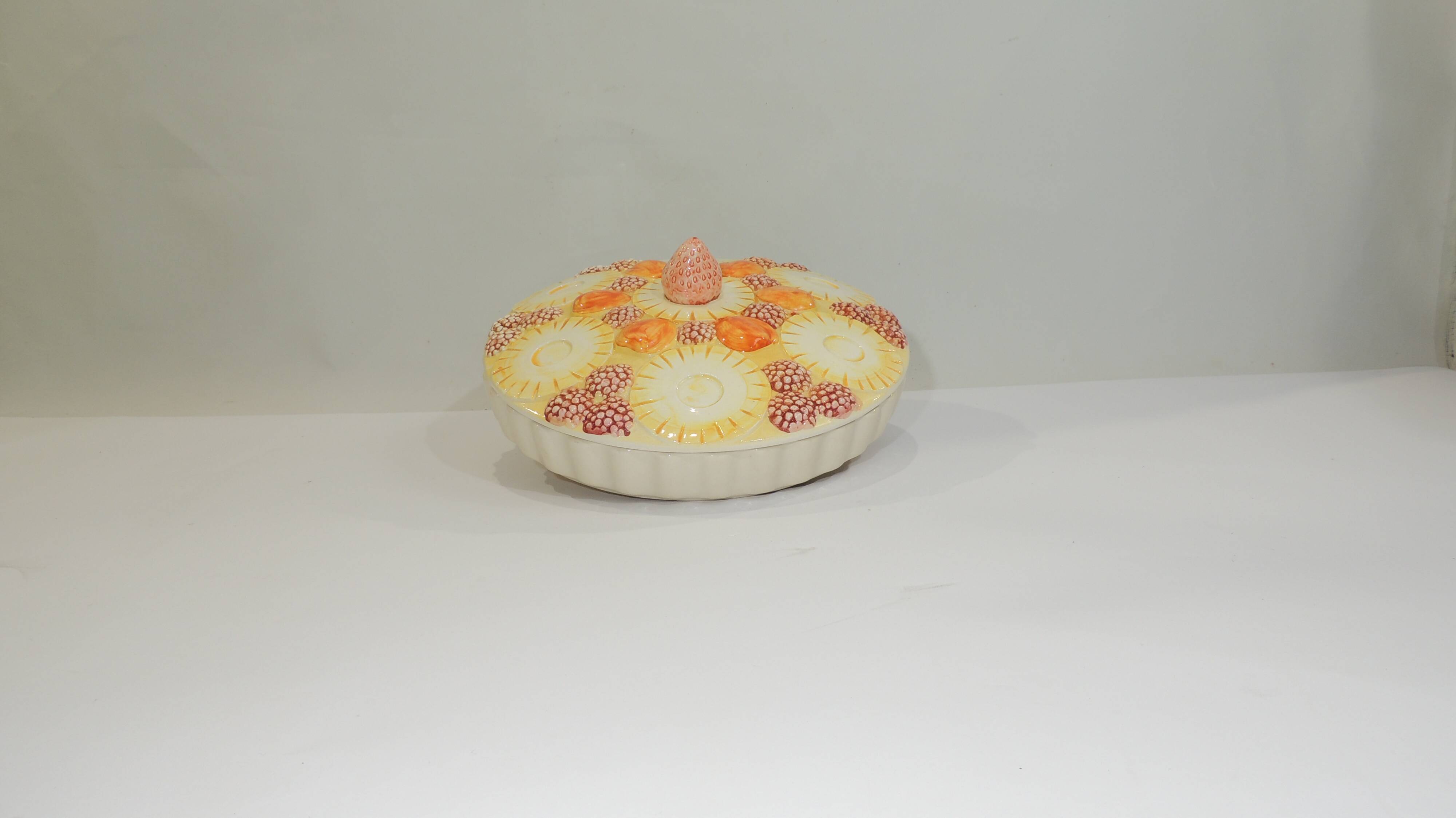 Magnificent fruit tart dish in slip signed "What's Vincent Cadeaux