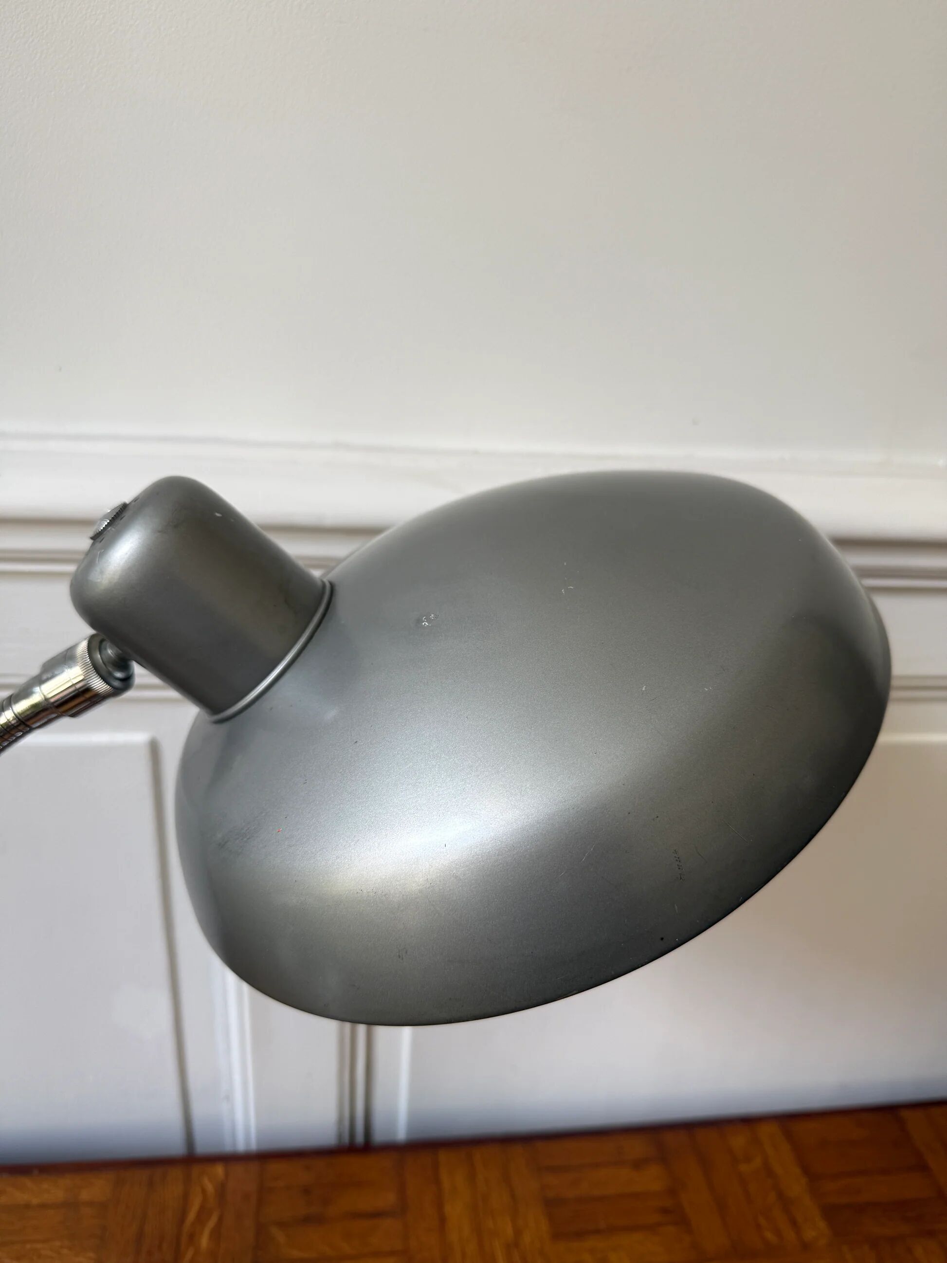 Industrial metal workshop lamp with a gooseneck.