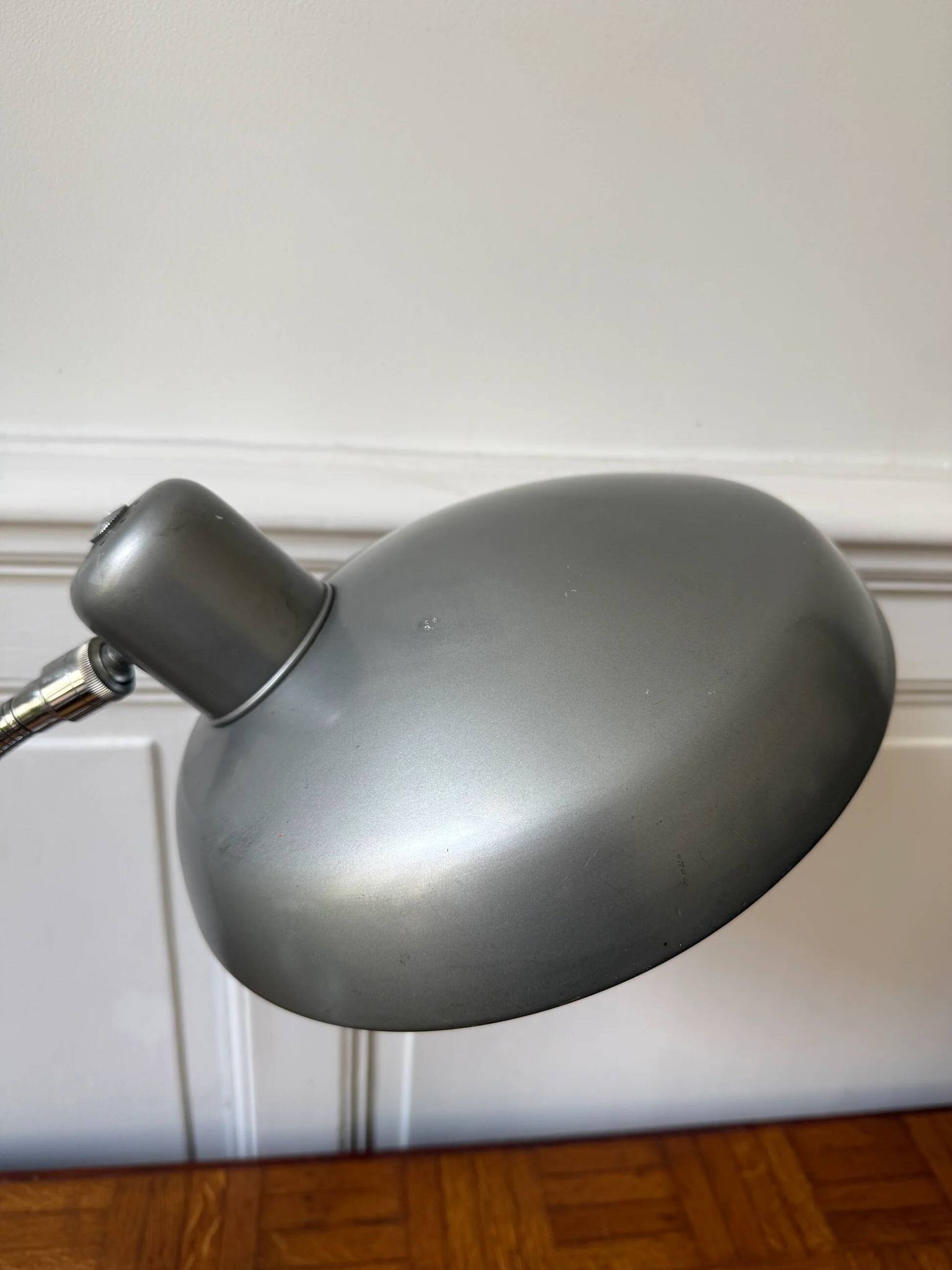 Industrial metal workshop lamp with a gooseneck.