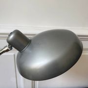 Industrial metal workshop lamp with a gooseneck.