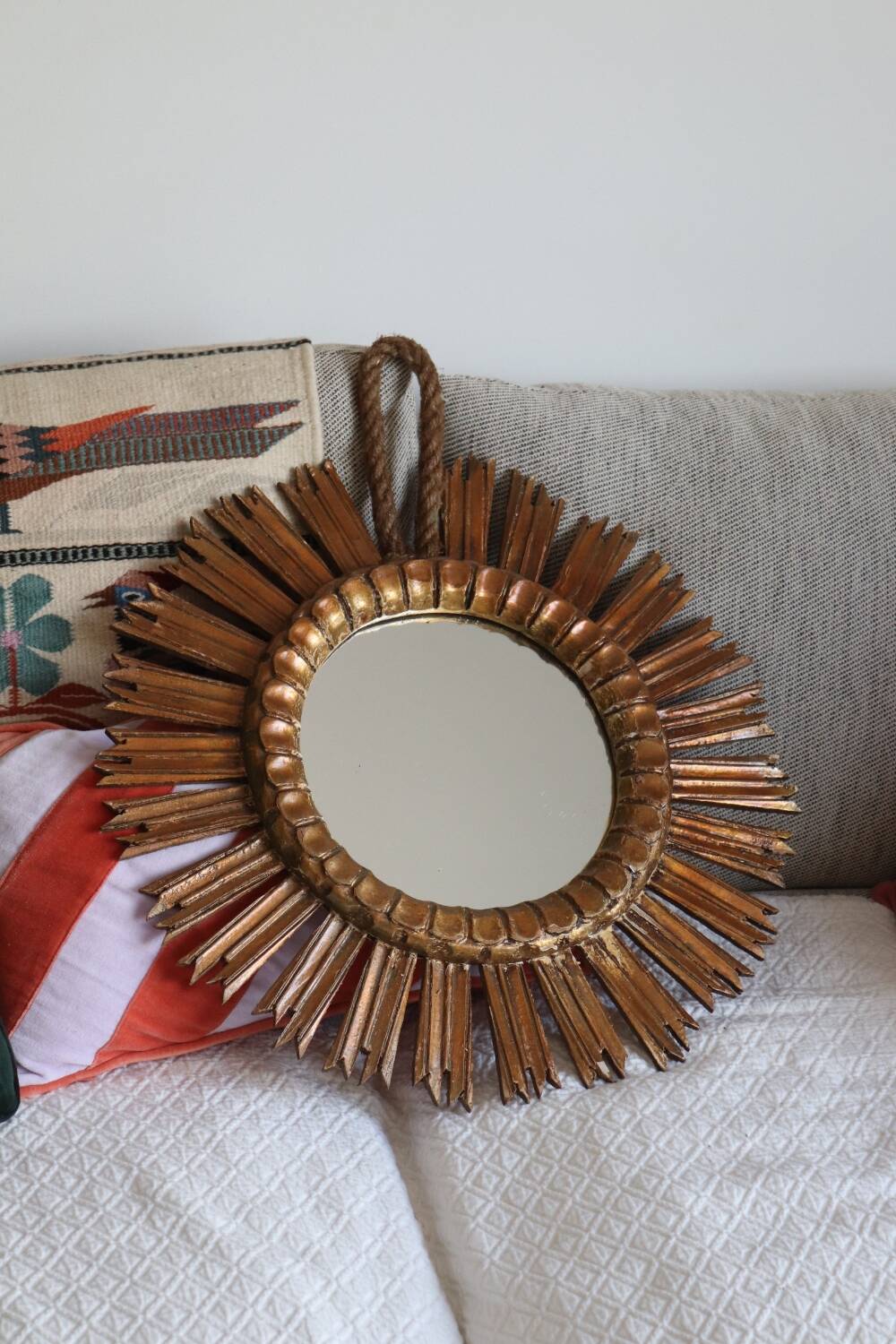 Old large sun mirror in gilded wood