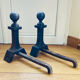 Pair of massive antique-style fire dogs in solid iron from the 20th century.