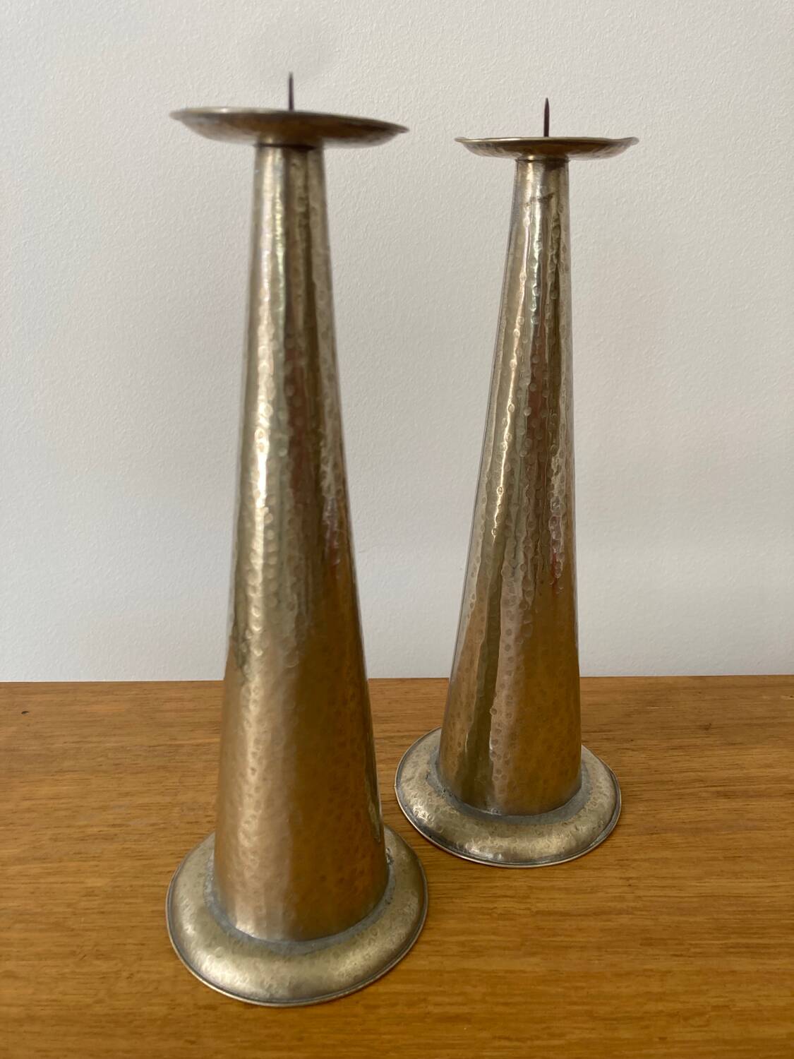 Pair of hammered metal candlesticks