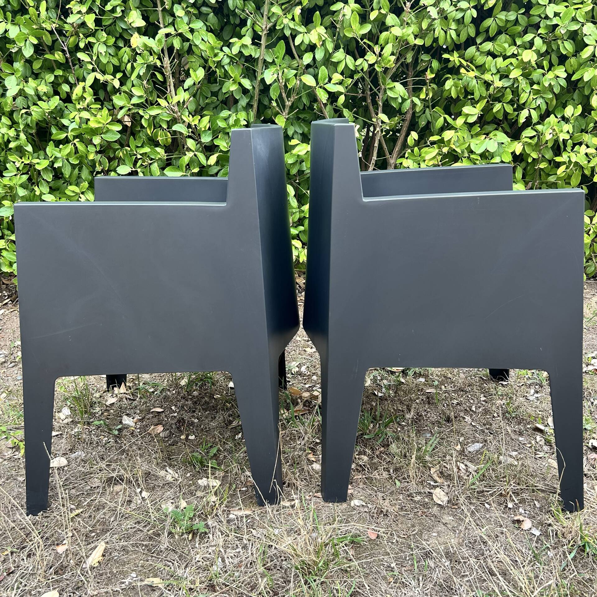 2 black Toy chairs designed by Starck