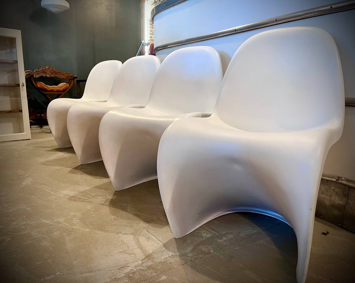 4 white Panton style armchairs
