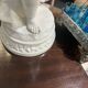 Child statue with flowers in porcelain, signed.