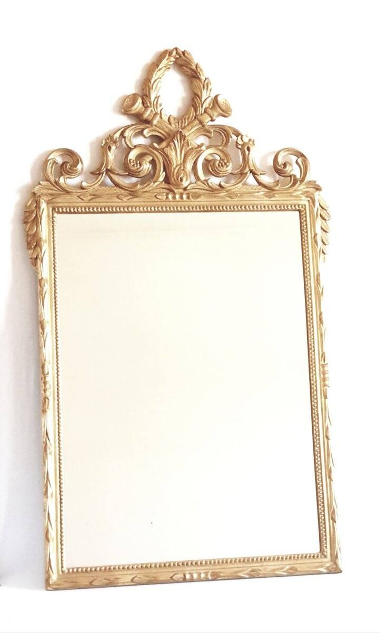 Golden mirror in the Louis XVI style from the 20th century.