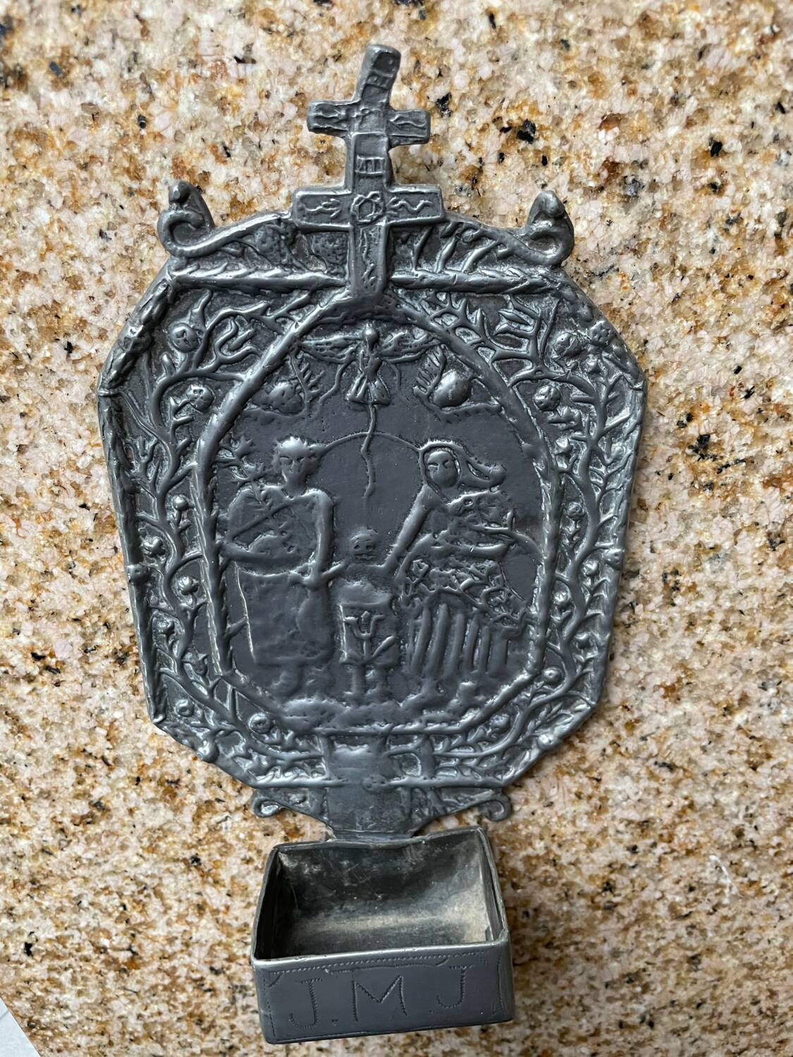 Small wall-mounted holy water font