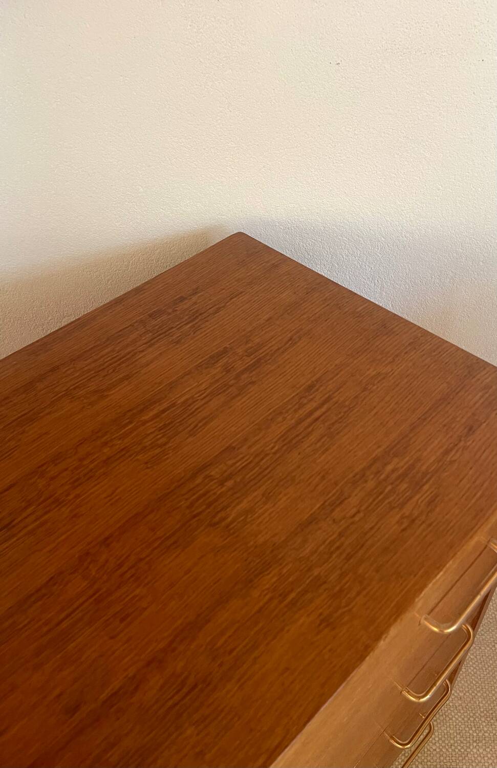 Vintage 1960s chest of drawers with covered handles.