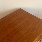 Vintage 1960s chest of drawers with covered handles.