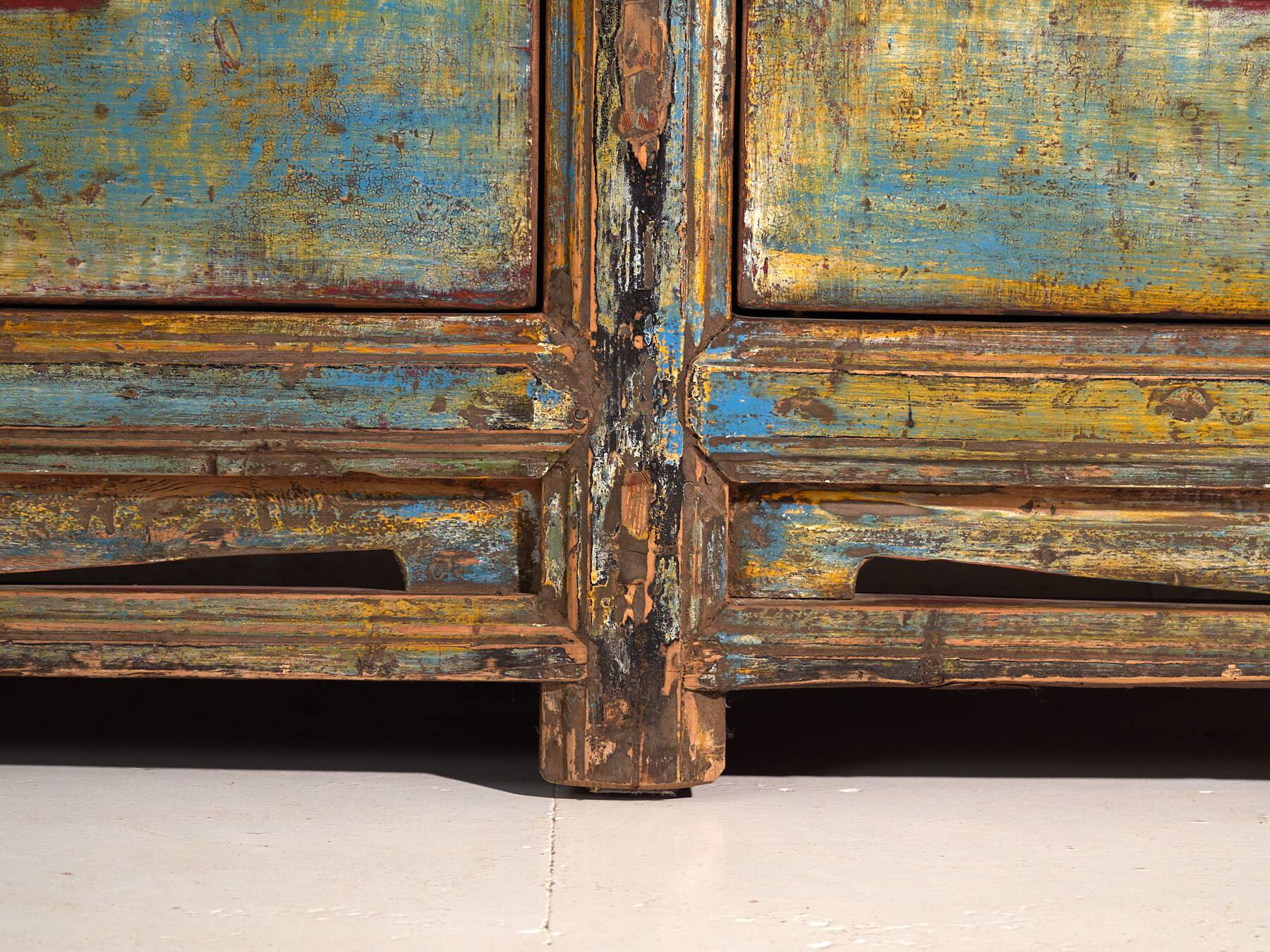 Old wooden entrance buffet in blue and yellow tones (circa 1920).