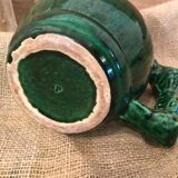 Porcelain pitcher in the shape of a barrel, with its handle that looks like a vine stock