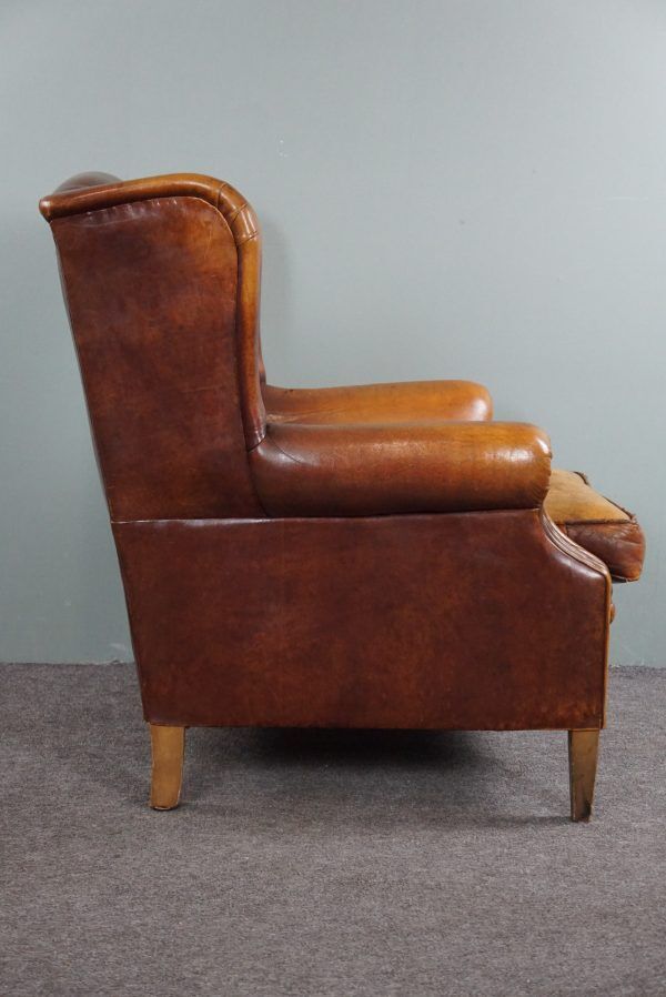 Armchair in patinated sheepskin leather
