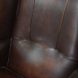 Comfortable wingback chair in English style made of cowhide leather