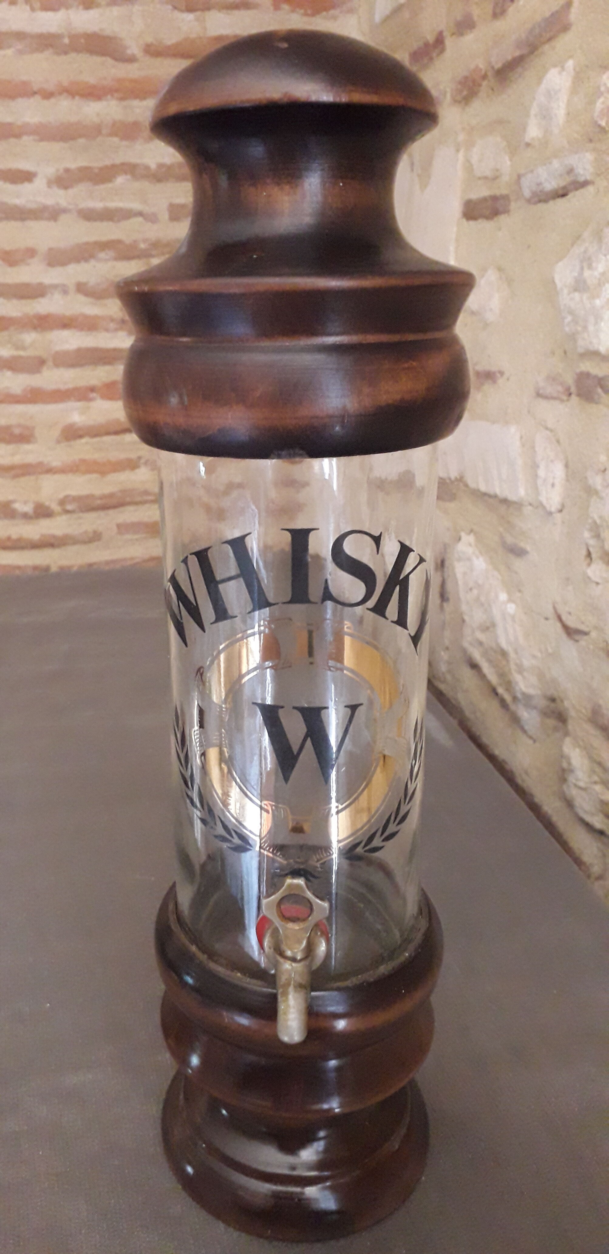 Vintage glass and wood whiskey bottle with pouring tap