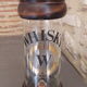 Vintage glass and wood whiskey bottle with pouring tap