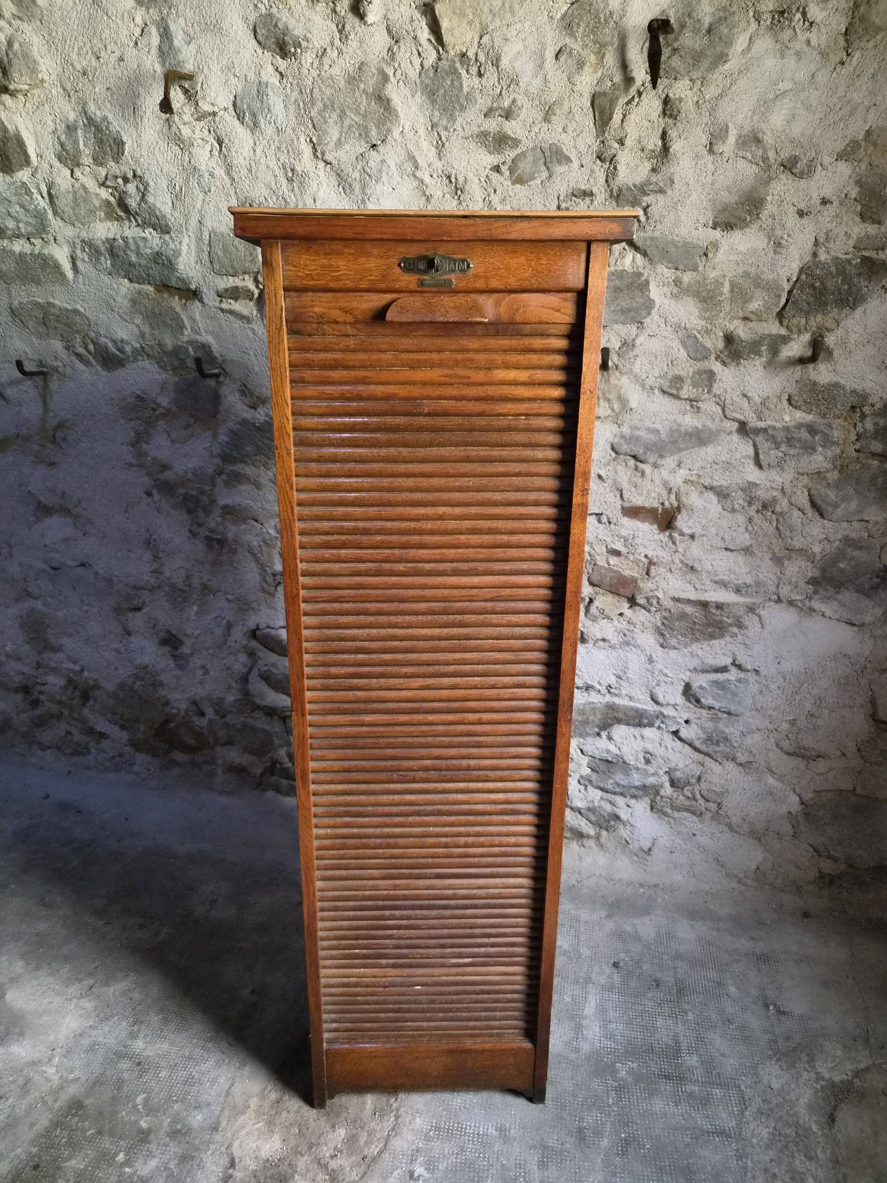 French antique wardrobe with curtain in oak, circa 1920–1930.