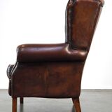 Luxurious sheepskin armchair with a fixed seat cushion and high seating comfort
