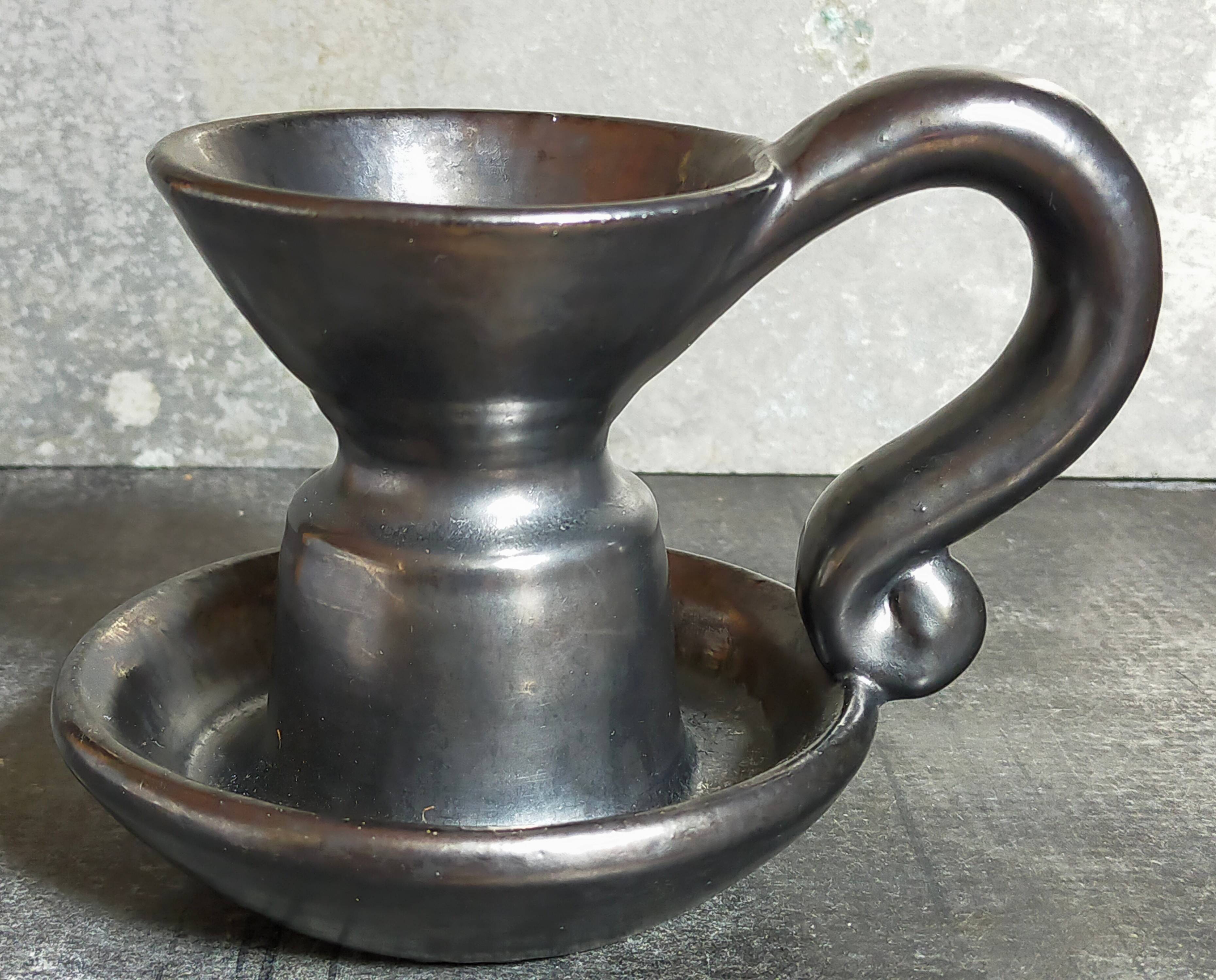 1950s iridescent black ceramic hand candle holder