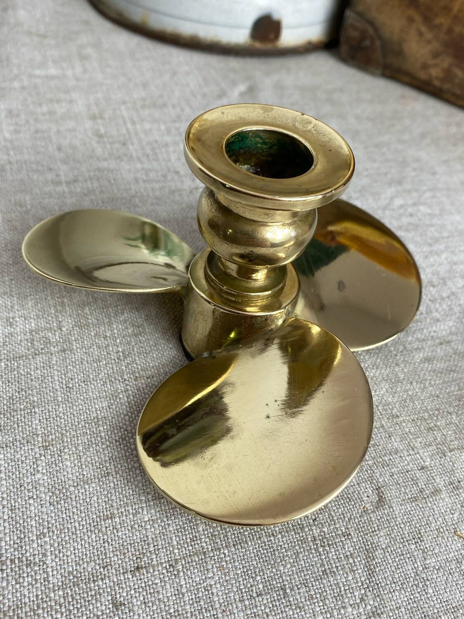 Pair of vintage brass propeller-shaped candlesticks