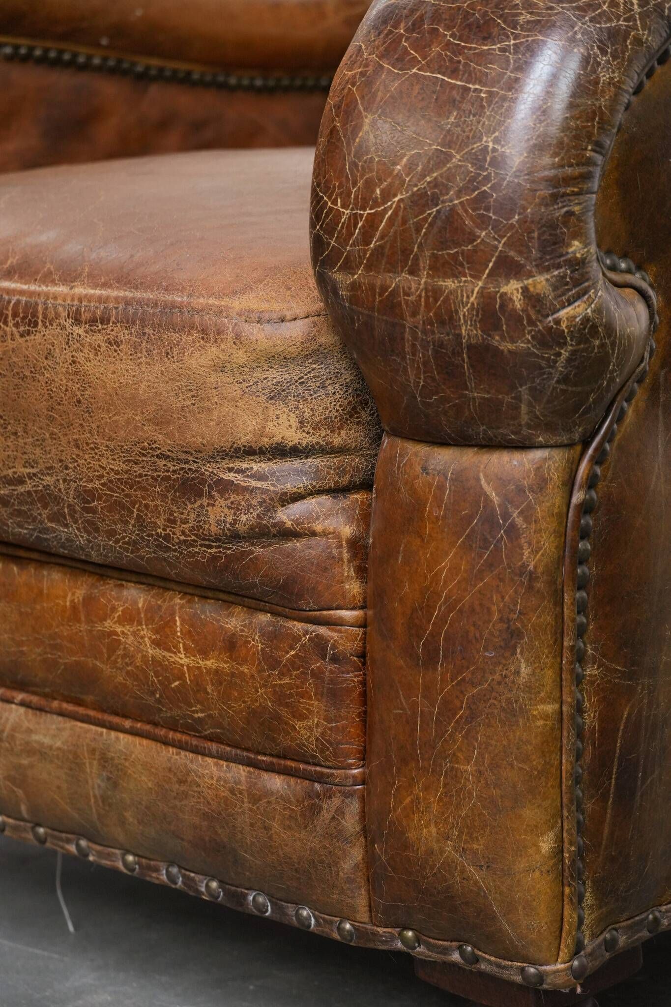 Charming and comfortable vintage armchair in grained cowhide leather with character