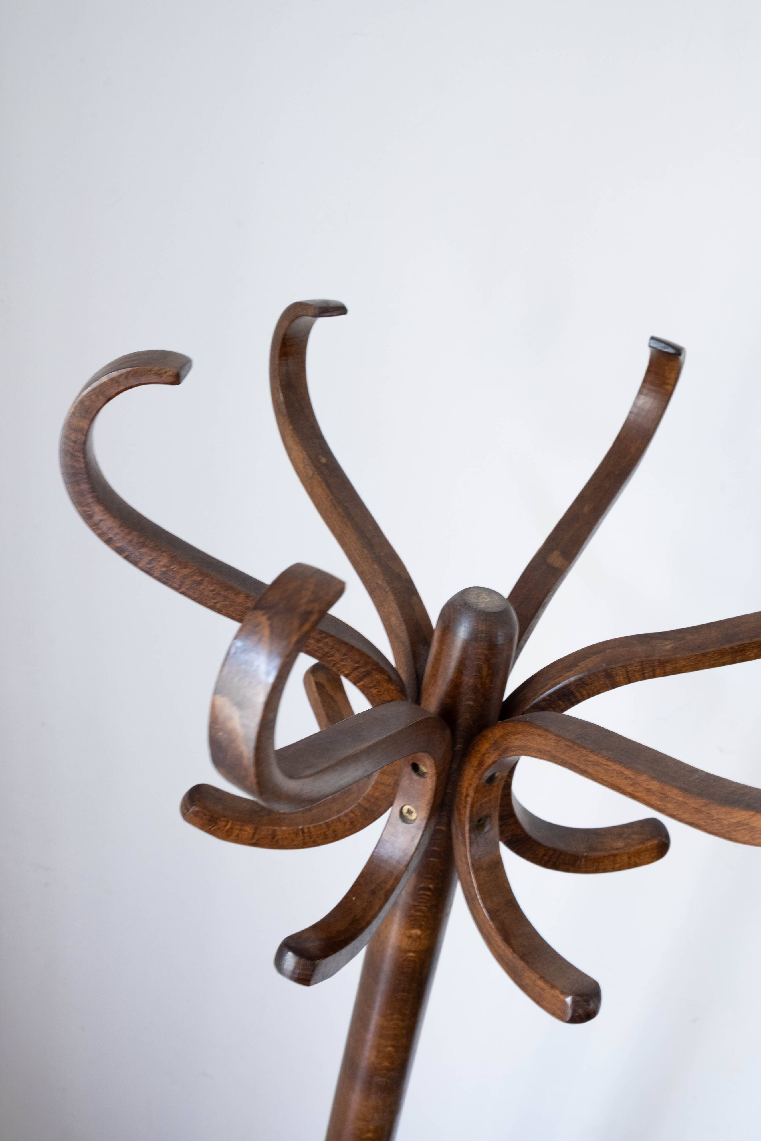 Baumann swivel parrot coat rack, dark wood.