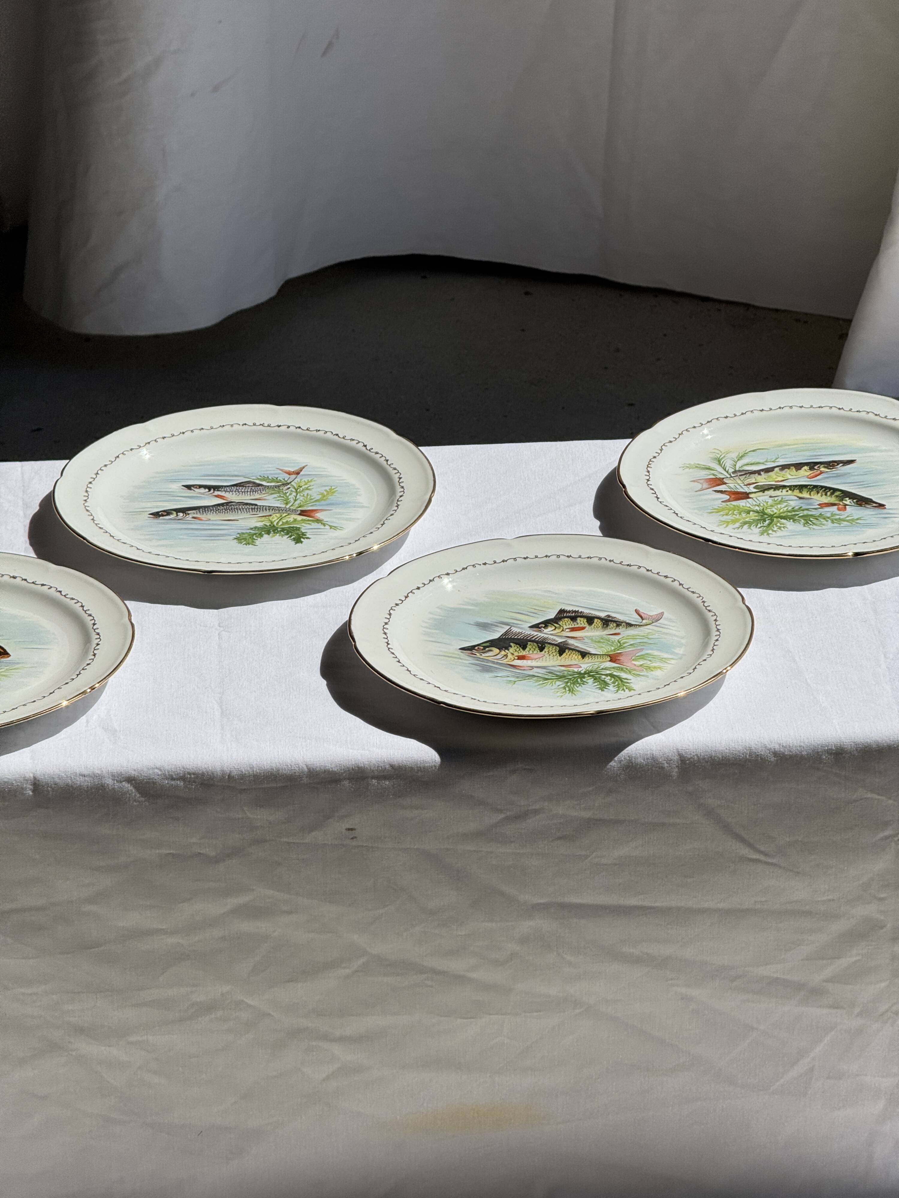Set of 6 vintage Limoges porcelain plates with fish design.