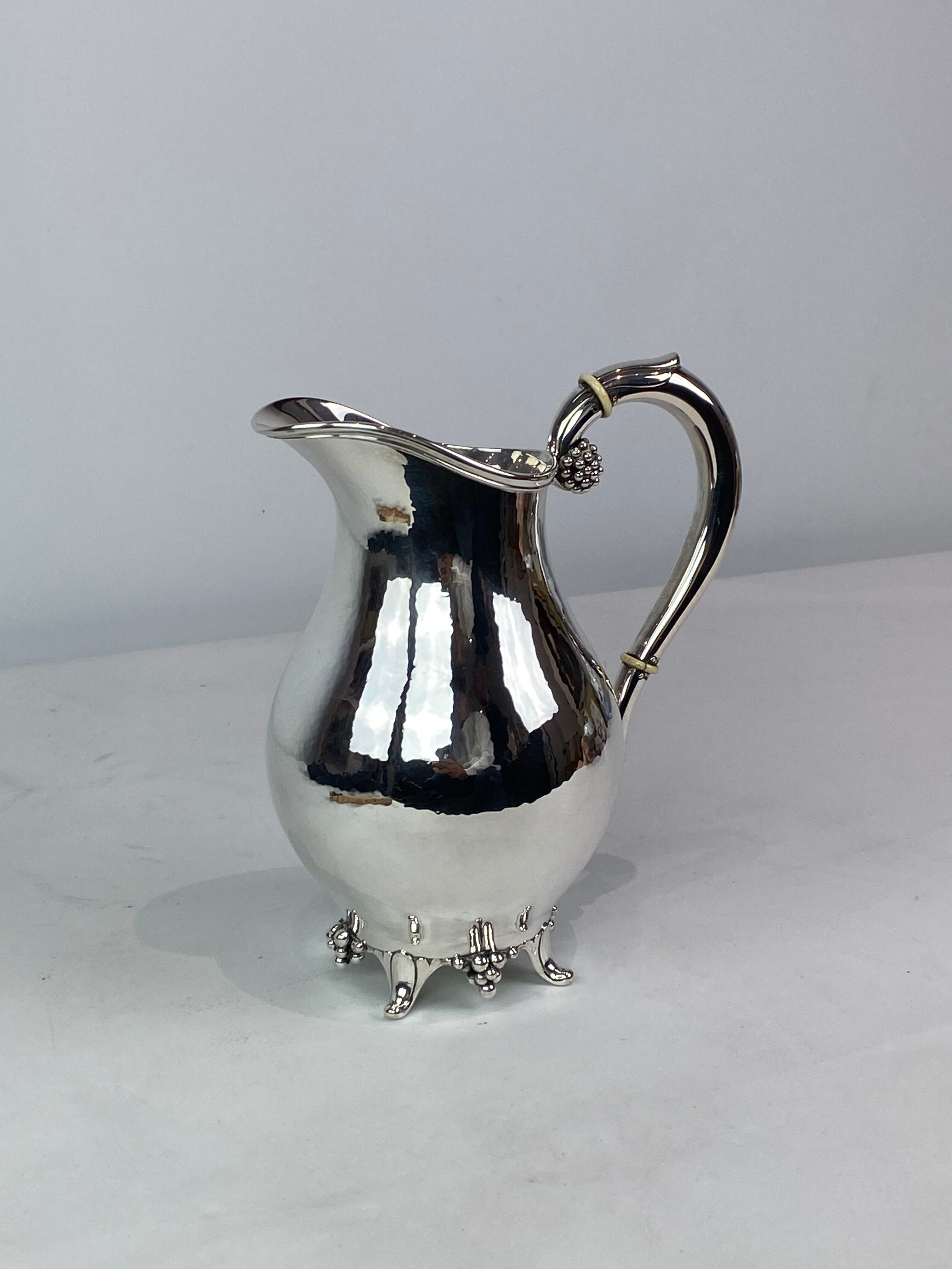 Water jug on feet decorated with ebony of hallmarked silver from the 1940s. The jug is in great anti