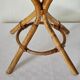 Vintage double-sided round mirror on a rattan stand.