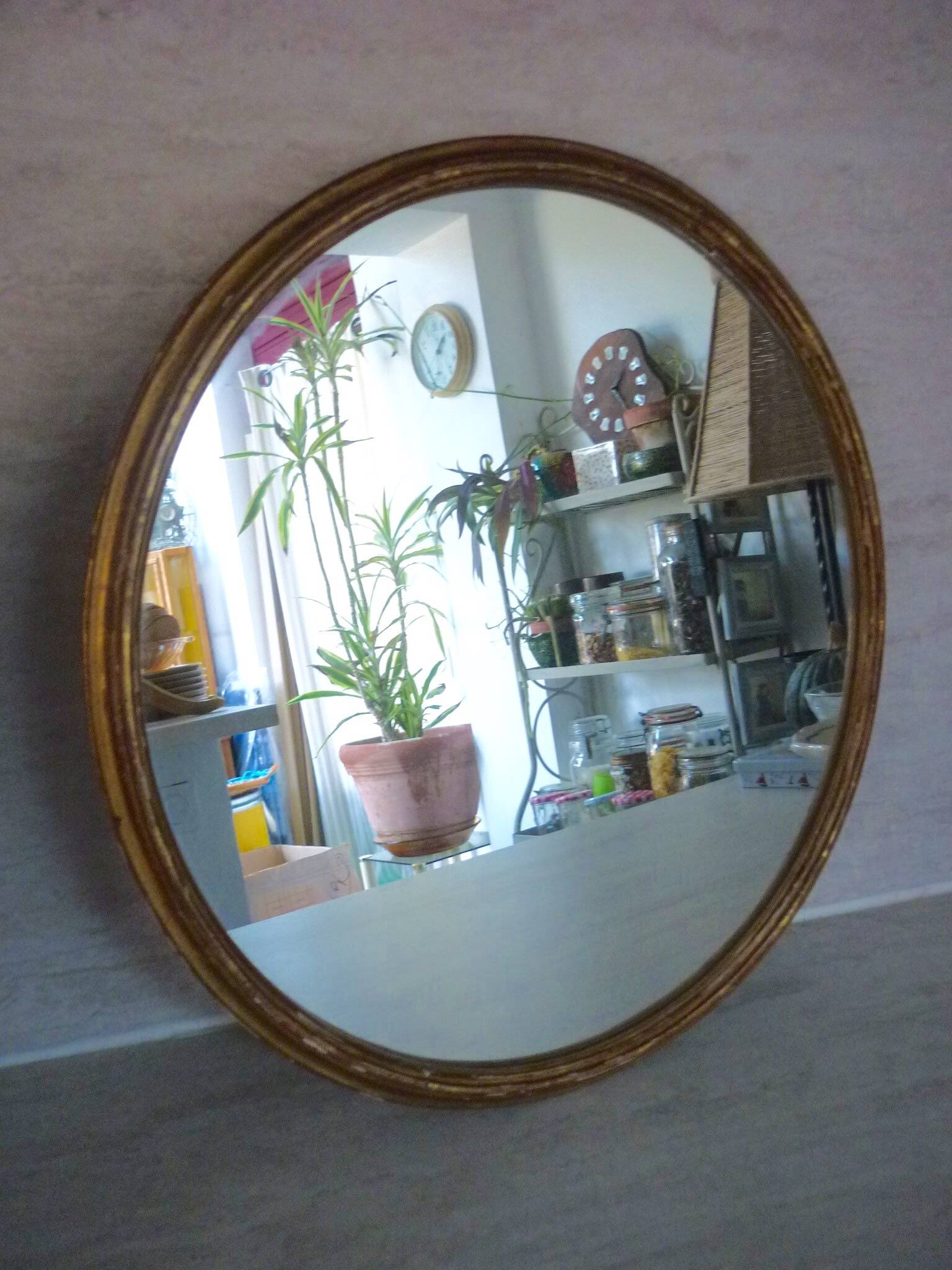 Old gilded wood oval mirror