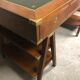 Walnut desk with green leather top resting on two trestles