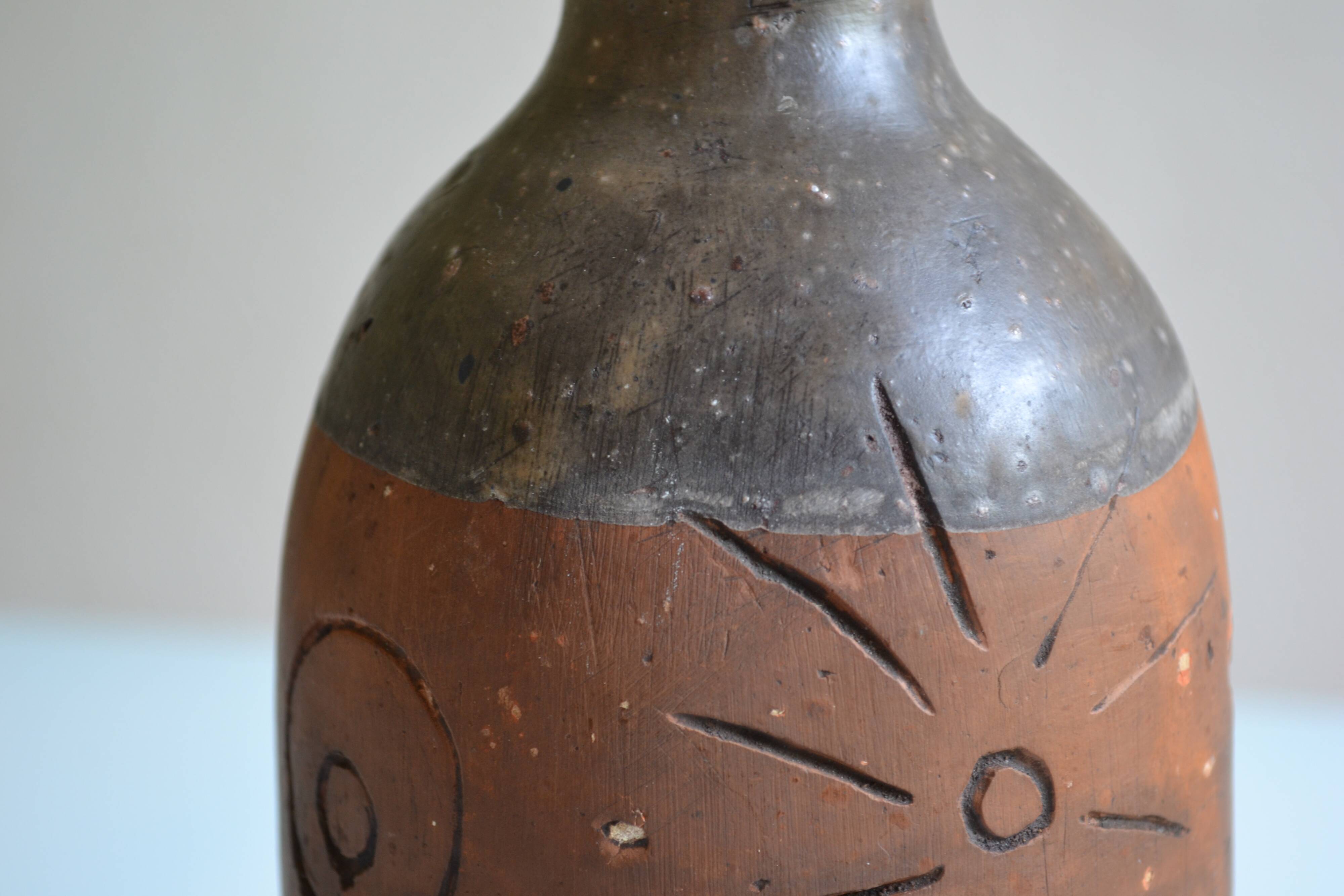 Bottle vase decorative flowers ceramic signature with fish to identify.