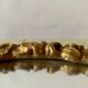 Small vintage oval wall mirror in varnished gold resin