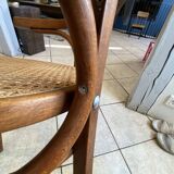 Bistro chair with a curved wooden frame and caned seat from the 1930s.