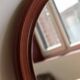 Round vintage mirror with mahogany wood effect frame.