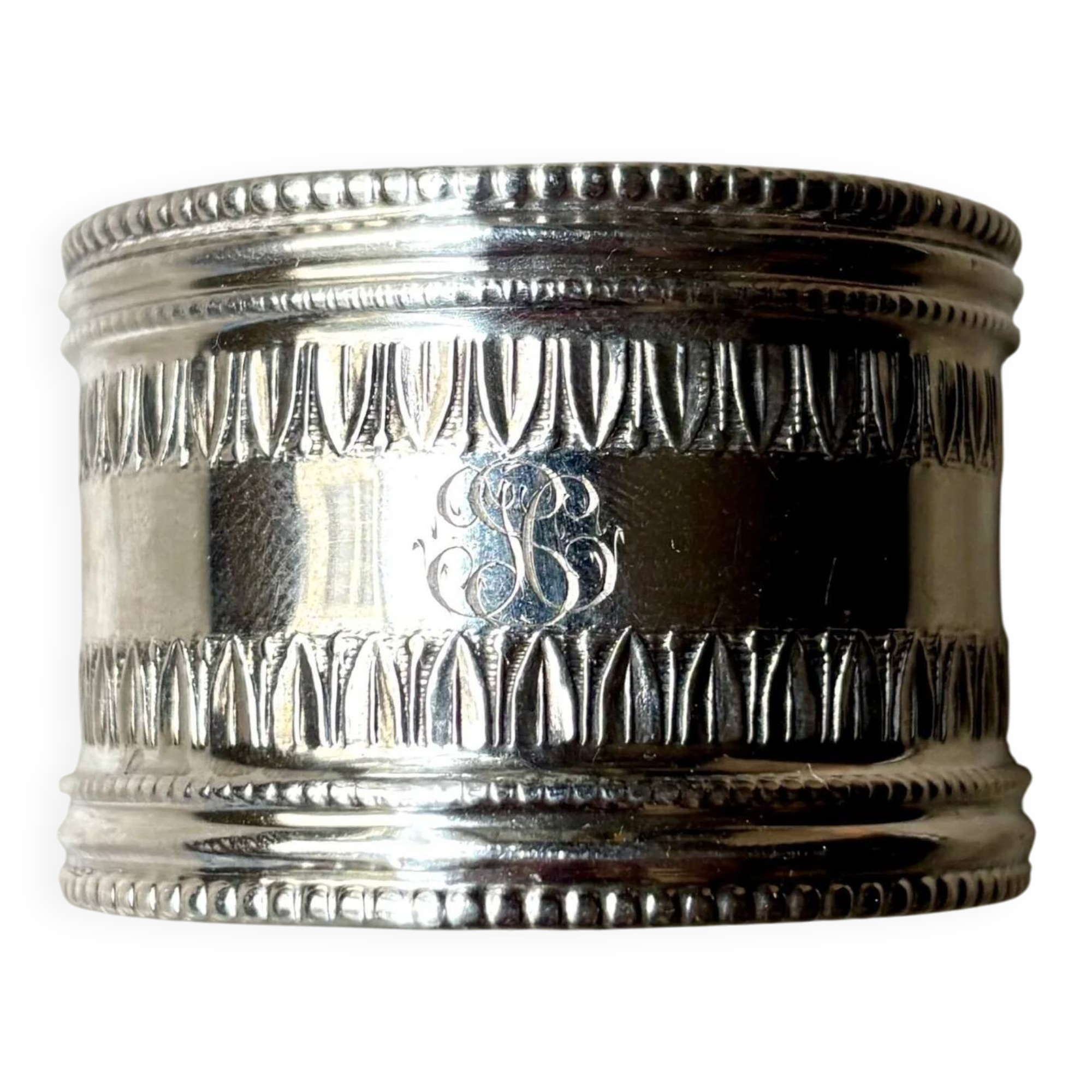 Monogrammed silver napkin ring with palmette and beaded motifs