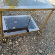 Vintage golden metal rolling dessert trolley
