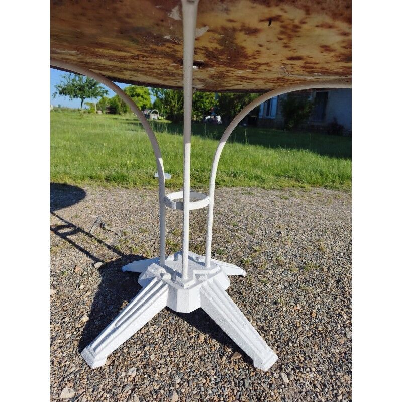 Garden table with a cast iron base and a metal top.