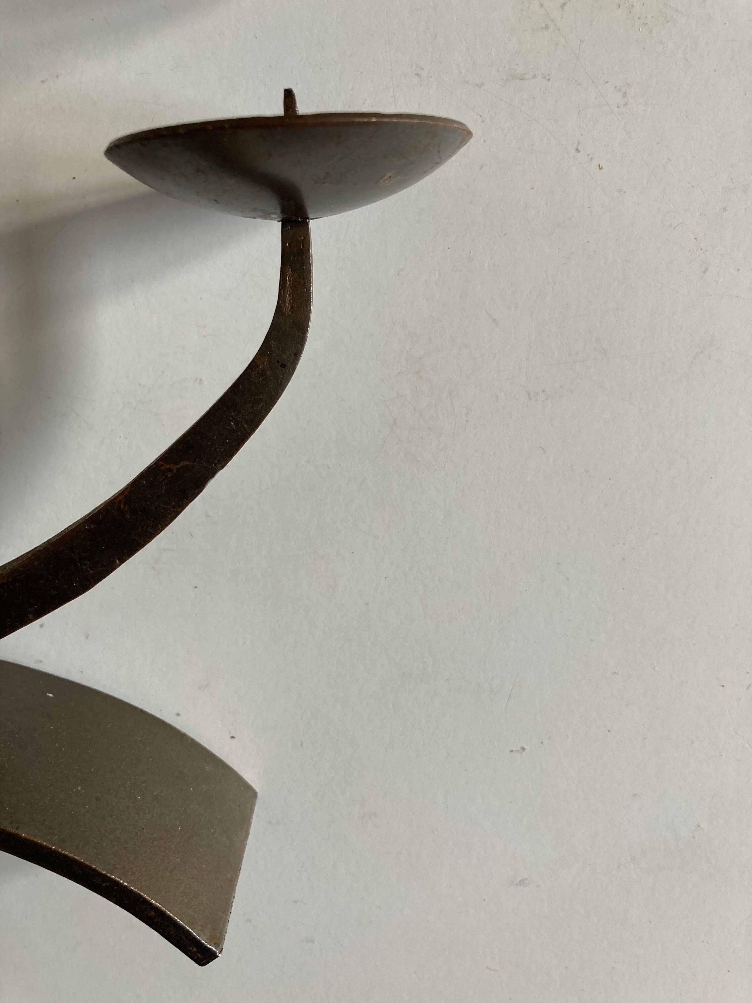 Pair of modernist candlesticks in beaten iron 1970
