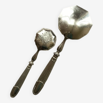 Old dessert cutlery spoon for sprinkling sugar and strawberry spoon in silver metal