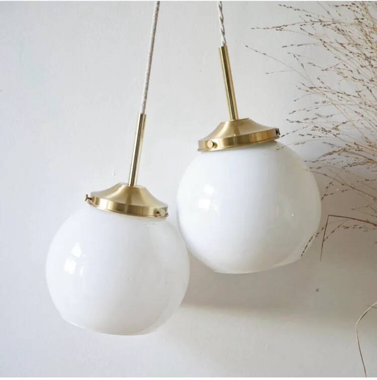 A pair of white opaline and brass suspensions.