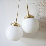 A pair of white opaline and brass suspensions.
