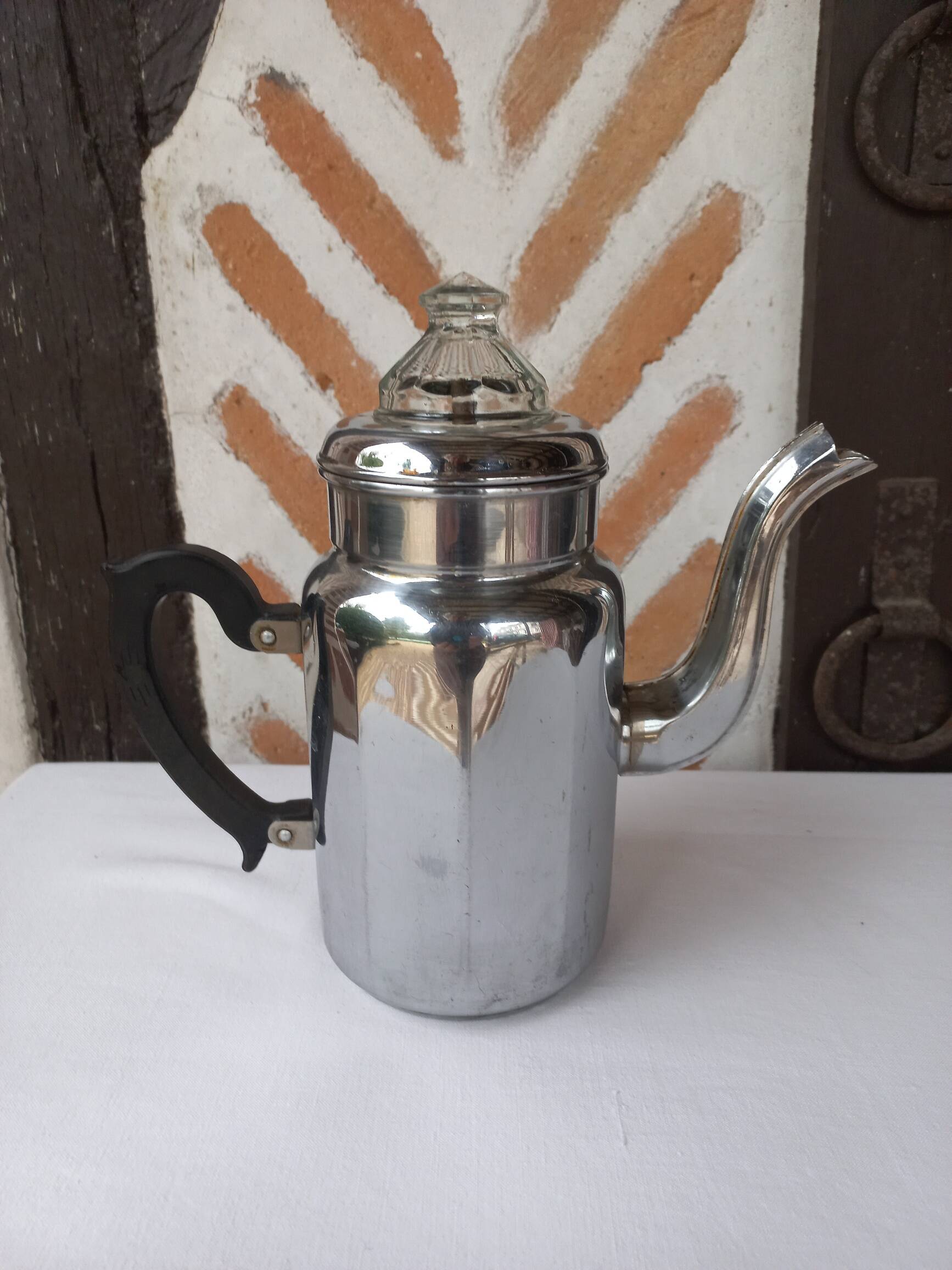Silver metal coffee maker with glass cap