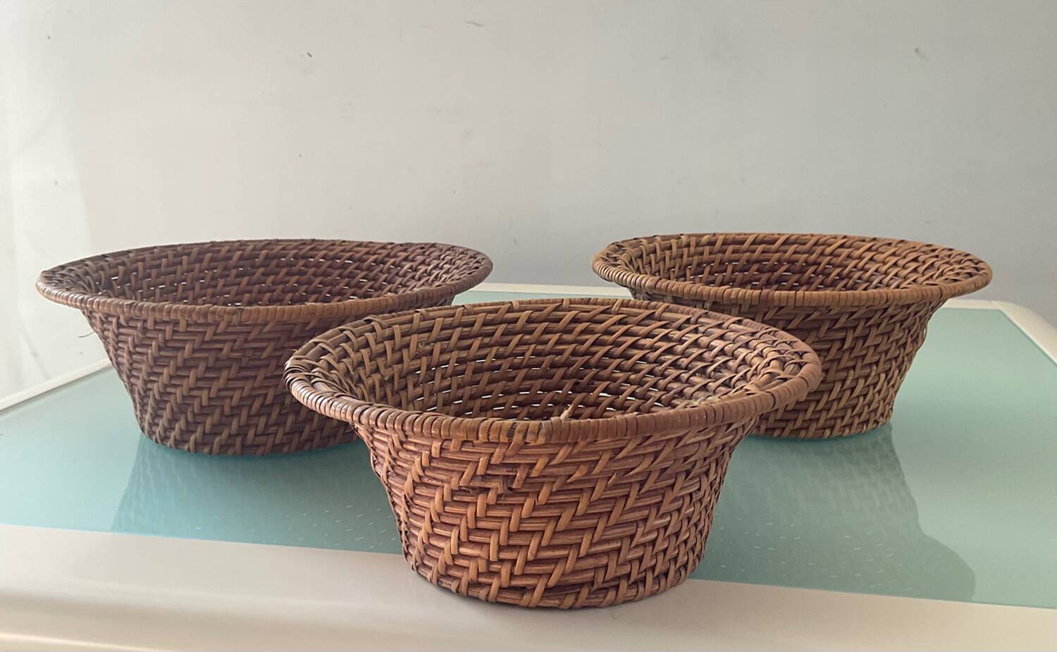 Trio of vintage woven rattan and wicker baskets