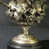 Carved silver bronze vase mounted on marble pedestal