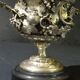 Carved silver bronze vase mounted on marble pedestal