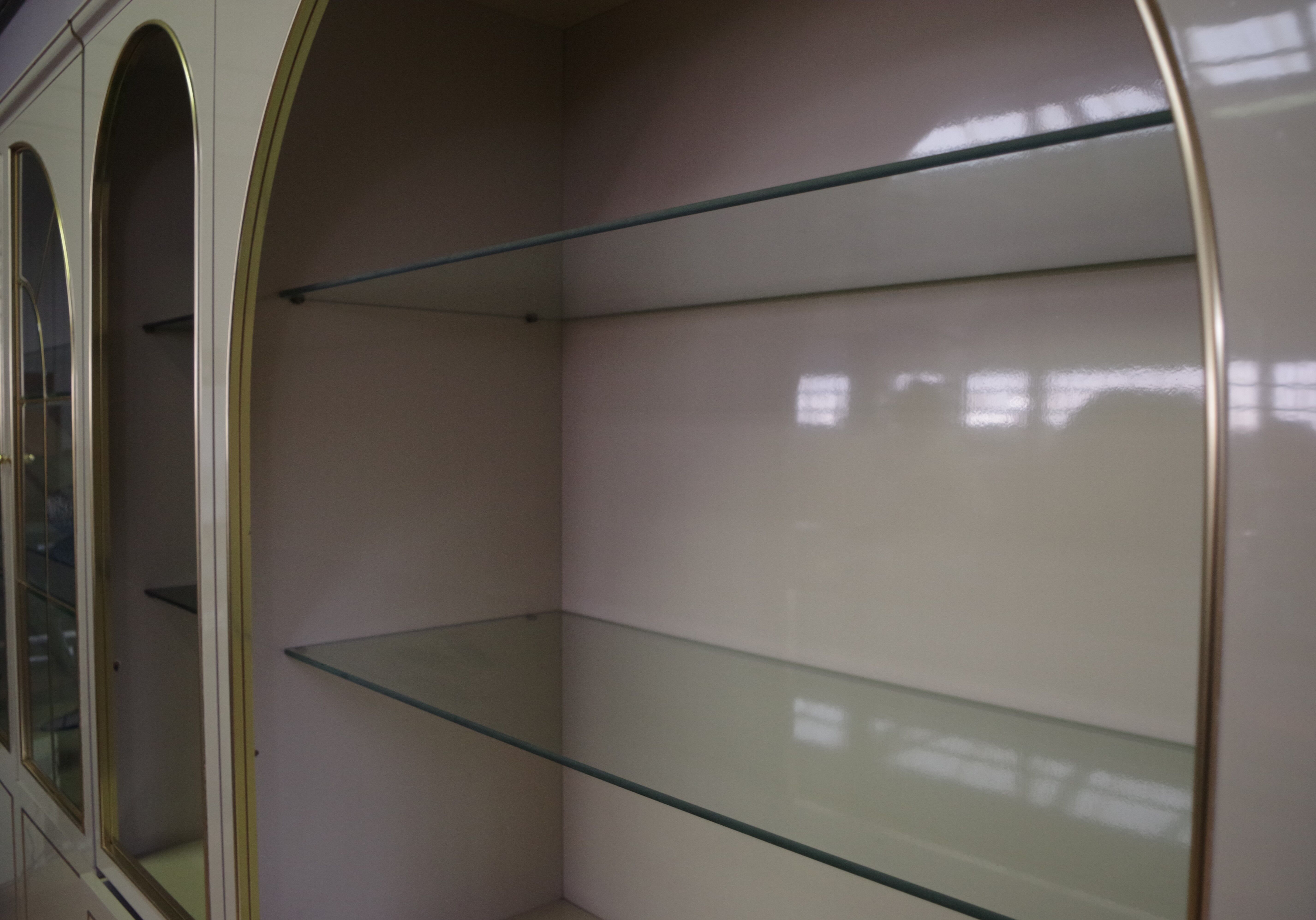 Showcases in lacquered wood, glass and brass  1970s, set of 4