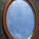 Old oval mirror, walnut wood tower, gilded border